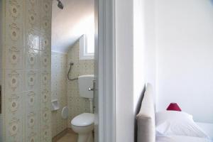 a small bathroom with a toilet and a sink at Argonaftis Spetses in Spetses