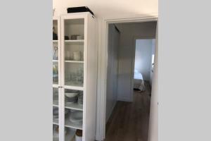 a white cabinet with dishes in it in a room at Country house between Egmond aan Zee & Amsterdam in Castricum
