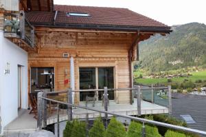 a log cabin with a deck and a balcony at Eggetli in Zweisimmen