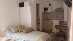 a small room with a bed and a kitchen at City Center Guest house in Valencia