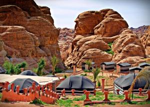 um grupo de tendas em frente a uma montanha em Seven Wonders Bedouin Camp em Wadi Musa