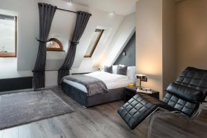 ein Schlafzimmer mit einem Bett und einem Stuhl in der Unterkunft Aparthotel New Lux in Breslau