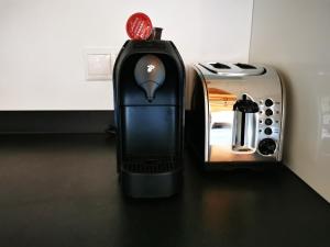 a black iron sitting on a counter next to a toaster at Apartments in Blockhaus im Wald in Siegsdorf