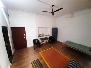 a living room with a table and a couch at Beds & Boys Hostel in Nagpur