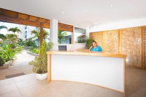 a man sitting at a counter in a room at Naboo Resort & Dive Center - Adults Only in West Bay