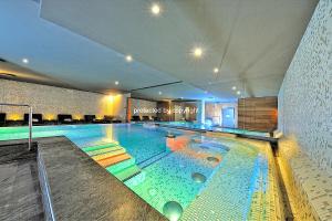 a large swimming pool in a building at Campiglio Luxury Apartment with SPA in Madonna di Campiglio