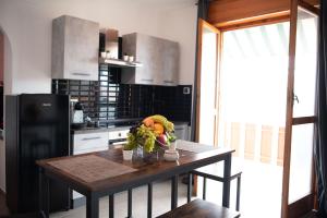 a kitchen with a table with fruits and vegetables on it at CS LUXURY HOUSE in Lido di Ostia