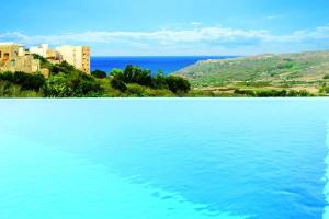 The swimming pool at or close to FIFTY-FOUR Edge Pool House - GOZO