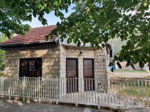 a small building with a fence in front of it at Studio Milenic in Trebinje