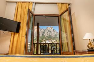 a hotel room with a view of the mountain at Famissi Hotel in Kalabaka
