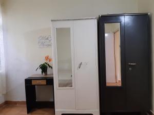 a room with a mirror and a cabinet and a desk at Palm Grove 1 Bhk Apartment at Candolim Beach with free Wifi in Candolim