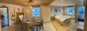 a large room with a bed and a dining table at Au doux gîte in Bras-Haut