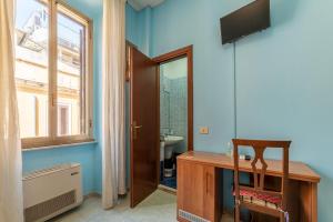 a bathroom with a desk and a sink and a window at Hotel Beauty Palace - Vertex Group in Rome