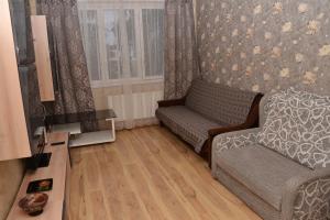 a living room with a couch and a tv at Imanta Apartment Riga 2х Rooms 52м2 in Rīga