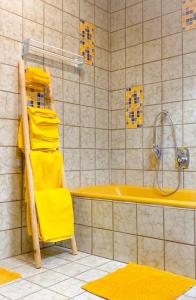 a yellow towel rack in a bathroom with a tub at Ferienwohnung Diesbrunnen in Ebermannstadt