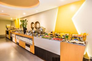 a buffet line in a hotel room with food at Hotel American Golf in Barranquilla