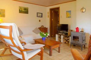 a living room with a couch and a table at La Petite Maison in Six Planes +12 photos