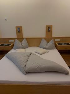 a large white bed with two pillows on it at Ferienwohnung Schweng in Tux