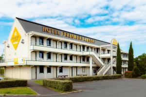 a hotel with a sign on the side of it at Premiere Classe Nevers Varennes Vauzelles in Varennes Vauzelles