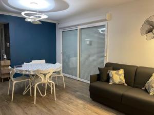 a living room with a table and a couch at Escapade de Vauclair in Bouconville-Vauclair