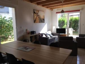 a living room with a wooden table and chairs at Gite des 3 cigognes in Colmar