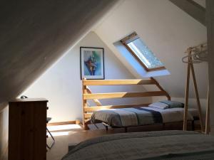 a bedroom with two beds in a attic at Gite des 3 cigognes in Colmar