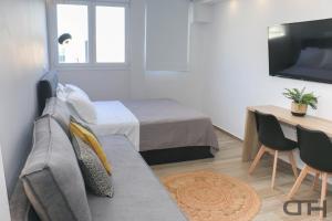 een woonkamer met een bank en een bed bij New deluxe studio 1 downtown Thessaloniki-Fully equipped in Thessaloniki