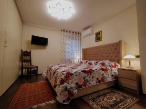 1 dormitorio con 1 cama y TV en la pared en Verona City San Zeno Apartment, en Verona