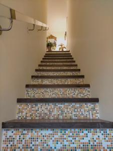 a stairway with tiled floors and a stair case at Verona City San Zeno Apartment in Verona
