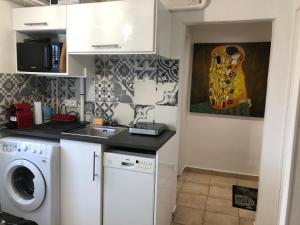 a kitchen with a sink and a washing machine at Room in house near Lycee International St Germain en Laye in Saint-Germain-en-Laye