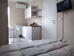 una camera con letto e una cucina con tavolo di la casa all 'angolo a Pisa