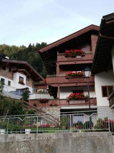 a building with flower boxes on the balconies at rima apartments in Hippach
