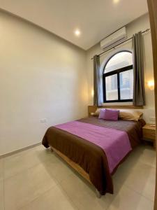a bedroom with a large bed with a window at Diamonds Luxury apartment - Julia in Marsalforn