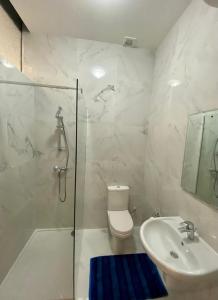 a bathroom with a shower and a toilet and a sink at Diamonds Luxury apartment - Julia in Marsalforn