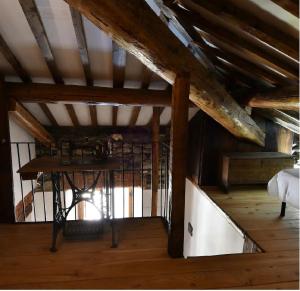 a attic room with a bed and a wooden floor at Il Rustico in Ronco Canavese