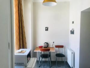 a small kitchen with a table and two chairs at my house in Tbilisi City