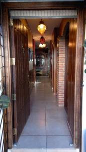 a hallway of a house with wooden doors and a chandelier at Hacienda en Primavera, descanso Familiar total in Puerto Vallarta