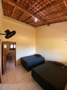 a room with two beds and a table in it at Casa na Praia in Luis Correia