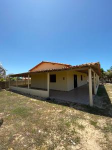 a small house with a roof at Casa na Praia in Luis Correia