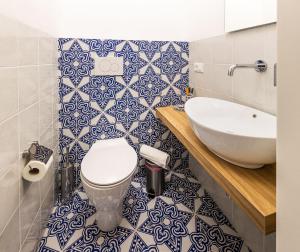 a bathroom with a toilet and a sink at La Maiolica in Noto Marina