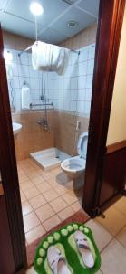 a bathroom with a toilet and a rug on the floor at Diyar Taiba Hotel in Medina +19 photos