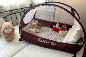 a crib filled with stuffed animals on a bed at Luxus house with Sauna Nearby Airport in Vantaa