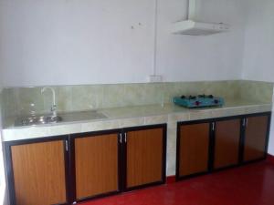 a kitchen with a sink and a counter top at Midland Hotel Rooms Kanampella in Kananpella +5 photos