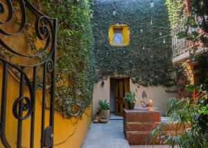 an entrance to a house with a door covered in ivy at Hotel Casa Pereyra in Oaxaca City