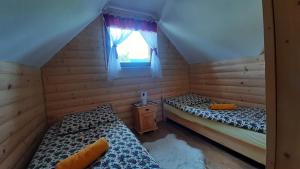 Posteľ alebo postele v izbe v ubytovaní Podhalańskie Domki u Magdusi i Marcina z Jacuzzi