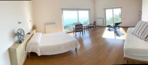 A bed or beds in a room at Stunning Design Villa with unique 180º sea views