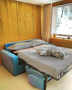 two twin beds in a room with a window at Achillea Alpina Cervinia apartment Vda Vacanze in Vetta CIR 0249 in Breuil-Cervinia