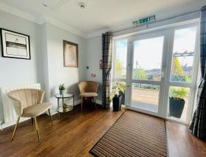 a living room with a sliding glass door at Bojangles Guest House in Gretna Green