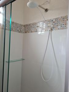 a shower with a glass door and a ceiling at Pousada Nossa Senhora Aparecida in Águas de São Pedro