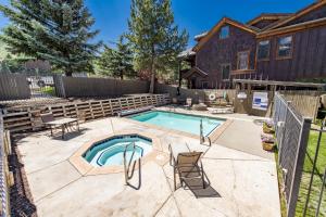 a swimming pool in a yard with a house at 2BD 2BA Condo with Hot Tub and Pool in Park City